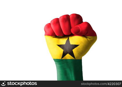 Low key picture of a fist painted in colors of ghana flag