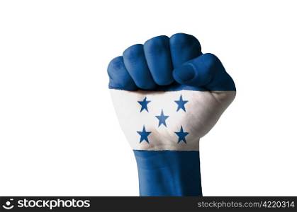Low key picture of a fist painted in colors of honduras flag