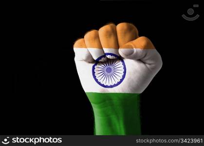 Low key picture of a fist painted in colors of india flag