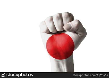 Low key picture of a fist painted in colors of japan flag