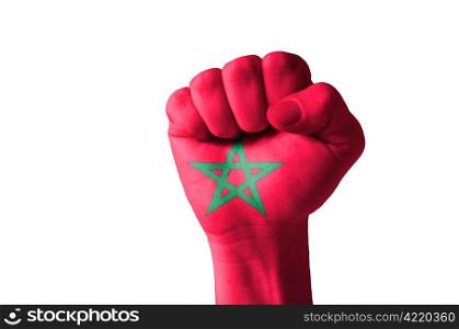 Low key picture of a fist painted in colors of morocco flag