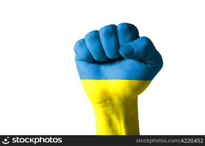 Low key picture of a fist painted in colors of ukraine flag