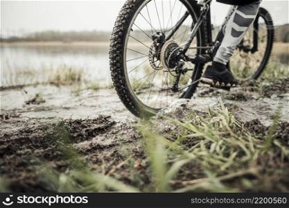 low section male cyclist riding bicycle mud