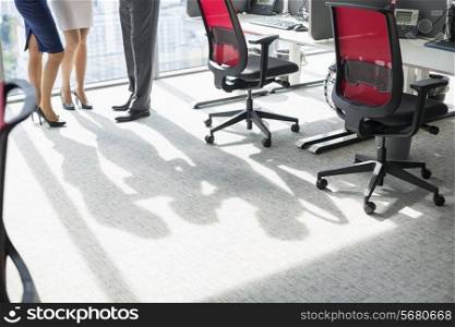 Low section of businesspeople standing in office