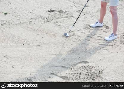 Low section of woman playing at golf course