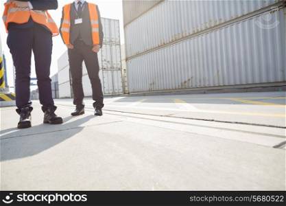 Low section of workers standing in shipping yard