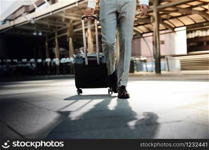 Low Section of Young Businessman Walking in the Modern Transport Terminal. Walk into the Camera. Lifestyle of Modern Traveler. Low Angle View