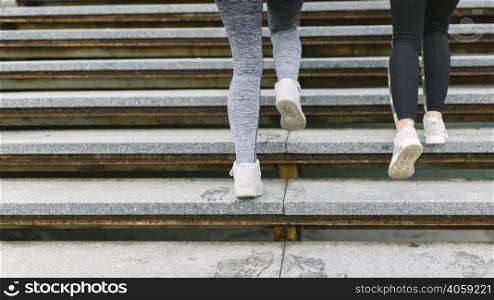 low section two female runner jogging staircases
