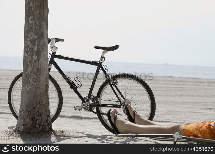 Low section view of a man relaxing on the beach