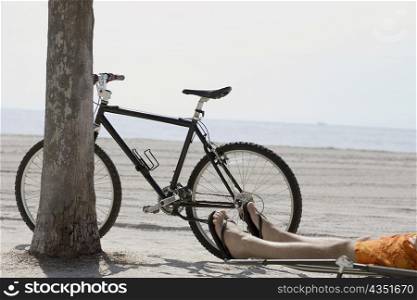Low section view of a man relaxing on the beach