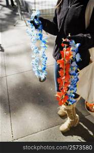 Low section view of a man selling garlands