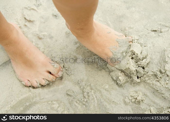 Low section view of a person&acute;s foot in sand