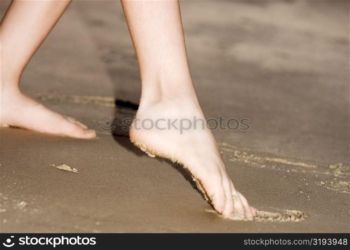 Low section view of a person playing in the sand