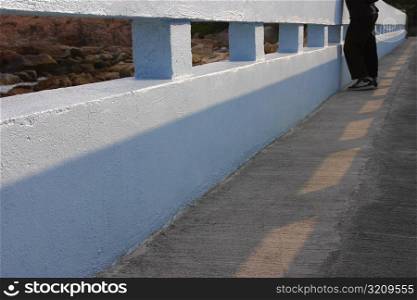 Low section view of a person standing on a bridge, Lantau, Hong Kong, China