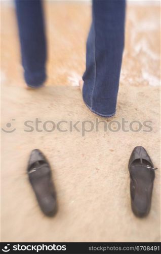 Low section view of a person standing on the beach