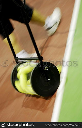 Low section view of a person walking on a tennis court