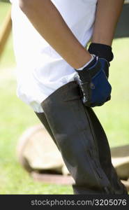 Low section view of a person wearing a riding boot