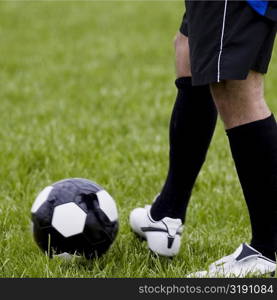 Low section view of a soccer player with a soccer ball