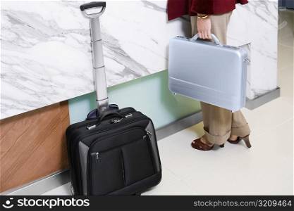 Low section view of a woman holding a briefcase