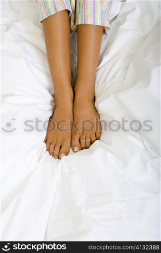 Low section view of a woman on the bed