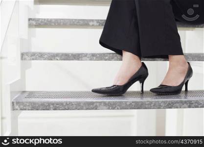 Low section view of a young woman sitting on a staircase
