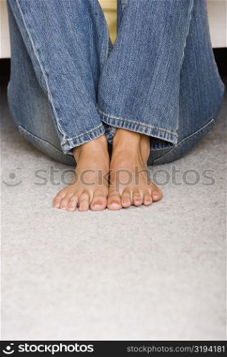 Low section view of a young woman sitting on the floor
