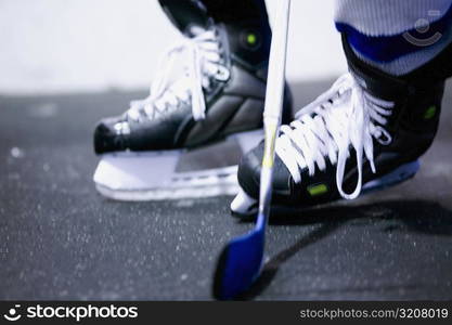 Low section view of an ice hockey player playing ice hockey