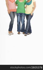 Low section view of three women standing together