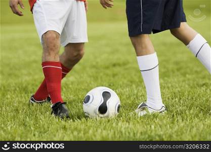 Low section view of two soccer players playing soccer