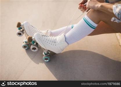 low section woman tying roller skate lace. High resolution photo. low section woman tying roller skate lace. High quality photo