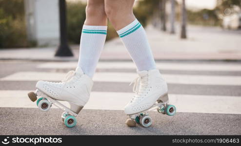 low section woman wearing vintage roller skate walking road. High resolution photo. low section woman wearing vintage roller skate walking road. High quality photo