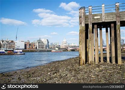 Low tide River Thames and London city skyline including St Paul&acute;s Cathedral