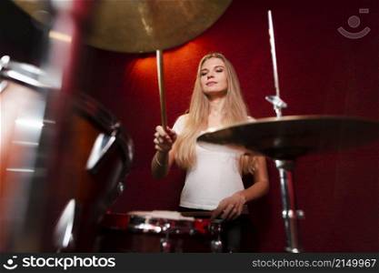 low view shot girl playing cymbals