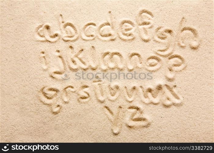 lower case alphabet written in sand - a designers tool