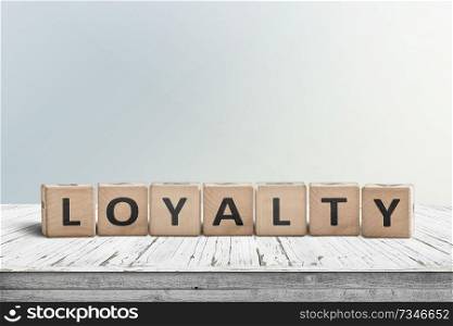 Loyalty sign on a wooden table in bright daylight in a room