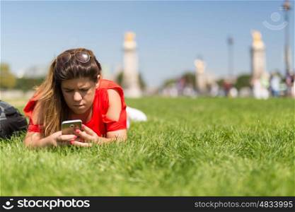 Lucky woman in Paris checking her smartphone for news