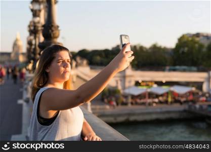 Lucky woman in Paris taking a selfie to post on social networks