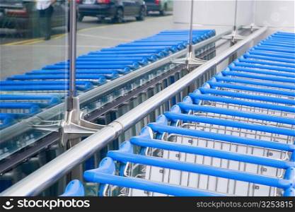 Luggage carts in a row at an airport