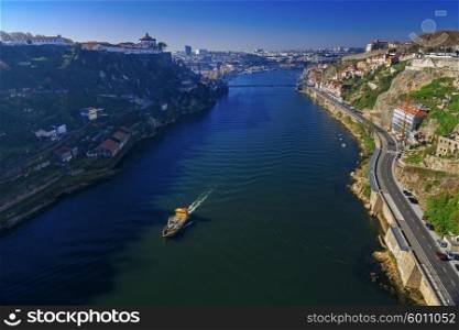 Luis I bridge and small ship sailing the river in Porto, Portugal, instagram toning&#xA;