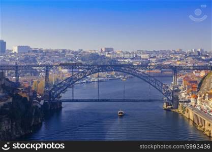 Luis I bridge and small ship sailing the river in Porto, Portugal&#xA;