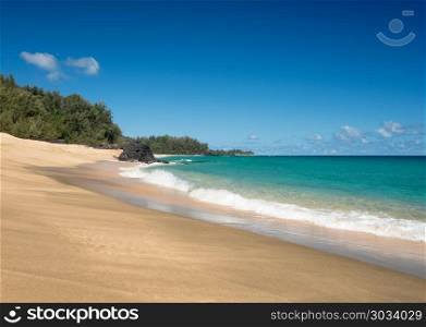 Lumahai Beach Kauai on calm day. Golden sands with warm turquoise ocean off Lumahai Beach in Kauai in Hawaiian islands. Lumahai Beach Kauai on calm day