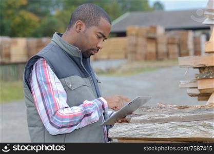 lumberyard clerk inspecting the products