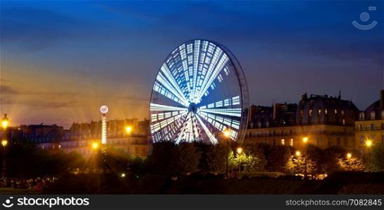 Luminous Ferris Wheel in the evening Paris, France
