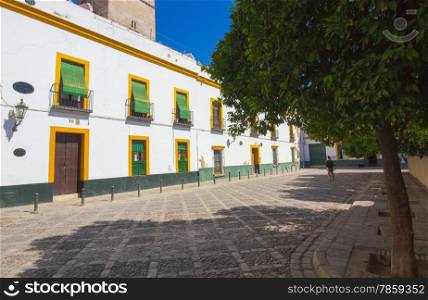 luminous square with typical white houses of Seville, Spain