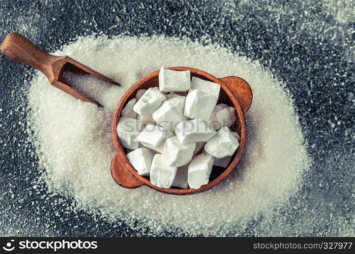 Lump and granulated refined sugar on the wooden background