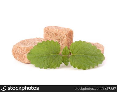 Lump brown cane sugar cubes isolated on white background