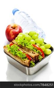 Lunch box with sandwiches, fruits and water on white background