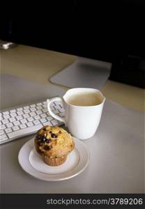 Lunch Break at the desk, coffee and muffin
