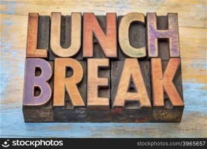 lunch break banner - text in vintage letterpress wood type printing blocks against grunge painted wood