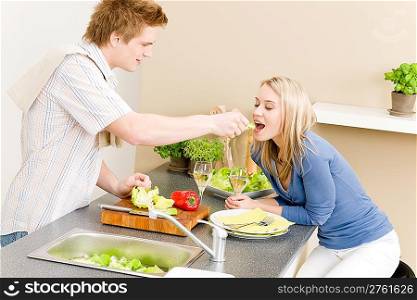Lunch couple cook salad man feeding woman in kitchen